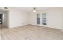 Spacious room with laminate flooring, ceiling fan, and patio doors to the exterior at 502 Brighton Pt, Atlanta, GA 30328