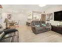 Open living room and dining area with wood-look flooring and modern lighting at 502 Brighton Pt, Atlanta, GA 30328