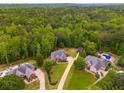 Aerial view of homes with pools and wooded areas at 7511 Biltmore Ln, Douglasville, GA 30135