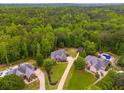 Aerial view of the property showcasing a home with a private backyard and pool at 7511 Biltmore Ln, Douglasville, GA 30135