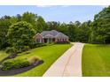 Beautiful brick home with a long driveway and lush landscaping at 7511 Biltmore Ln, Douglasville, GA 30135