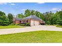Wide driveway to a brick house with an attached two-car garage at 7511 Biltmore Ln, Douglasville, GA 30135