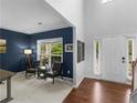 Cozy living room features a chair set, hardwood floors, and ample natural light at 973 Buckhorn Bnd, Locust Grove, GA 30248
