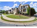 Street view of beautiful brick homes with landscaped yards and sidewalks in a desirable neighborhood at 11240 Avery Cove Ct, Alpharetta, GA 30022