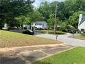 A tranquil street view of homes and trees showcases a peaceful neighborhood setting at 2545 Saint Patrick Se St, Atlanta, GA 30317