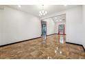 Open-concept living space featuring bright neutral walls and unique tile flooring at 2711 Mcdonough Rd, Hampton, GA 30228