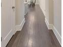 Inviting hallway with hardwood floors and white trim leading to a dining area at 396 Summerhour St, Marietta, GA 30060