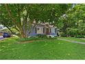 Charming blue home featuring a lush, well-maintained front yard at 511 Robinson Se Ave, Atlanta, GA 30315