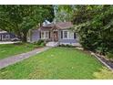 Inviting home with well-manicured lawn, landscaping, and a cozy front porch at 511 Robinson Se Ave, Atlanta, GA 30315