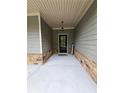 Inviting front entrance with a classic black door and decorative stone accents at 8315 Loch Lomand Ln, Winston, GA 30187