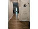 Hallway with wood floors leads to the rest of the home at 8315 Loch Lomand Ln, Winston, GA 30187