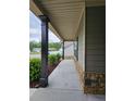 Covered porch with stone accents and dark columns creates a welcoming entrance at 8315 Loch Lomand Ln, Winston, GA 30187