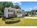 Inviting two-story home with manicured landscaping and a well-maintained lawn, creating a serene outdoor space at 3504 Benthollow Ln, Duluth, GA 30096