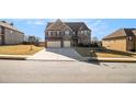 Charming two-story home features a two-car garage, landscaped yard, and brick elevation at 3621 Guinevere Trce, Douglasville, GA 30135