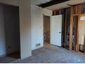 A bedroom needing renovation, with exposed framing and drywall, showing its potential for customization at 4195 Turner Dr, Cumming, GA 30040
