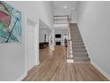 Inviting foyer showcasing hardwood floors and an elegant staircase at 5755 Vinings Place Se Ct, Mableton, GA 30126