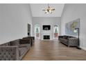 Bright living room featuring a fireplace, arched windows, and stylish gray sofas at 5755 Vinings Place Se Ct, Mableton, GA 30126