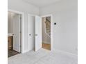 Neutral bedroom showcases a view of the stairs, walk-in closet, and en-suite bathroom with modern finishes at 2592 Alcovy Ne Trl, Marietta, GA 30066
