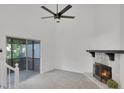 Bright living area with stone fireplace and sliding doors to screen porch for seamless indoor-outdoor living at 293 Quail Run, Roswell, GA 30076