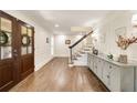 Elegant foyer with hardwood floors, wainscoting, and a staircase, creating a welcoming entrance at 1018 Layfield Ct, Dunwoody, GA 30338