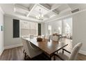 Elegant dining room with coffered ceilings, hardwood floors, and views of the living area at 139 Treeline Trl, Canton, GA 30115