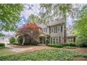 Charming two-story home featuring a well-manicured lawn, symmetrical design, and gray color palette at 5650 Buckleigh Pointe, Suwanee, GA 30024