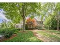 A well-manicured front lawn and meticulously maintained landscaping surround this lovely home at 5650 Buckleigh Pointe, Suwanee, GA 30024