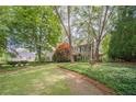 A well-manicured front lawn and meticulously maintained landscaping surround this lovely home at 5650 Buckleigh Pointe, Suwanee, GA 30024