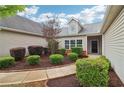 Inviting front entrance with landscaped shrubs, walkway, and neutral vinyl siding, creating an appealing first impression at 1065 City Park Dr, Mcdonough, GA 30252