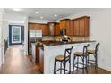 Well-lit kitchen features ample cabinets, granite countertops, stainless appliances, and breakfast bar seating at 1229 Concord Se Rd, Smyrna, GA 30080