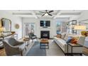Bright living room with fireplace, coffered ceiling, stylish furniture, and sliding doors to the outdoor patio at 1229 Concord Se Rd, Smyrna, GA 30080