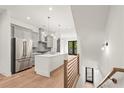Bright, open kitchen boasts stainless steel appliances, a large island, and wood floors, inviting modern elegance at 2327 Mason Dr # D23, Atlanta, GA 30316