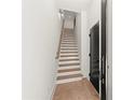 Entry hallway features a wooden staircase and a modern black door, blending style and functionality at 2327 Mason Dr # D23, Atlanta, GA 30316
