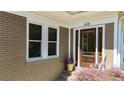 Inviting front entrance with brick facade, decorative flowers, and a stained wood door with glass panels at 608 Sherwood Ne Rd, Atlanta, GA 30324