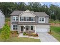 Charming two-story home boasts a well-manicured lawn, neutral colors, and inviting curb appeal at 6100 Misty Hill Ln, Buford, GA 30518
