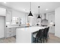 Modern kitchen with large island, sleek cabinets, and stainless steel appliances at 3319 Stillwood Ln, Hapeville, GA 30354