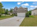 Charming brick home with a well-manicured lawn, two car garage, and a long driveway at 4050 Pleasant Woods Dr, Cumming, GA 30028