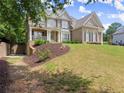 An attractive brick home with a landscaped front yard and a side-entry garage at 4525 E Point Dr, Cumming, GA 30041