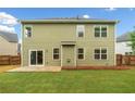Rear exterior view showing the home's siding, windows, and a small back patio at 508 Canton Ct, Canton, GA 30115