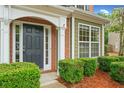 Close up of the front door with decorative molding and manicured landscaping at 508 Canton Ct, Canton, GA 30115