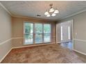 Open-concept dining area featuring neutral paint, large windows with natural light, and contemporary lighting at 1311 Bustling Sw Ln, Marietta, GA 30064