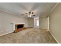 Spacious living room with classic brick fireplace, neutral paint, and ceiling fan at 1311 Bustling Sw Ln, Marietta, GA 30064