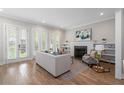 Bright living room with hardwood floors, fireplace, and French doors leading to the outside at 364 Glendale Ne Ave # B, Atlanta, GA 30307