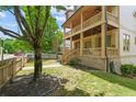 Charming home exterior with a double porch, lush green lawn, and a well-manicured landscape at 1858 Perry Nw Blvd, Atlanta, GA 30318
