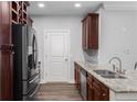 Spacious kitchen with stainless steel appliances, granite counters, dark cabinets, and hardwood floors at 901 Abernathy Ne Rd # 2050, Sandy Springs, GA 30328
