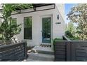 Front entrance to a modern townhouse, featuring a teal door, painted white brick and a dark metal awning at 1815 La Dawn Nw Ln, Atlanta, GA 30318