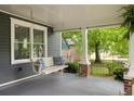 Inviting front porch showcases a swing, columns, and views of the lush front yard at 230 Milton Se Ave, Atlanta, GA 30315