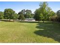 Spacious property with a lush green lawn and mature trees surrounding the home at 2604 Flat Shoals Sw Rd, Conyers, GA 30094