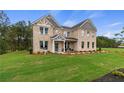 Charming two-story brick home with a well-manicured lawn and beautiful landscaping at 81 Homesite Hartsfield Rd, Mcdonough, GA 30253