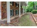 Exterior features of a two-story brick home, showing a well-maintained lawn and landscape at 3539 Evans Mill Rd, Lithonia, GA 30038